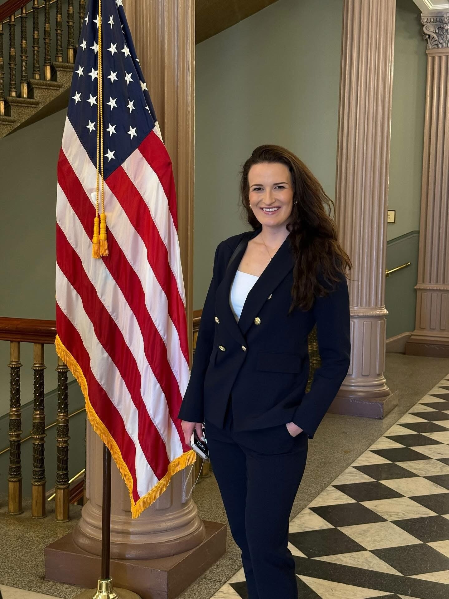 Taylor Talley, founder of Freedom Fighters Prevention Program, standing with the American flag